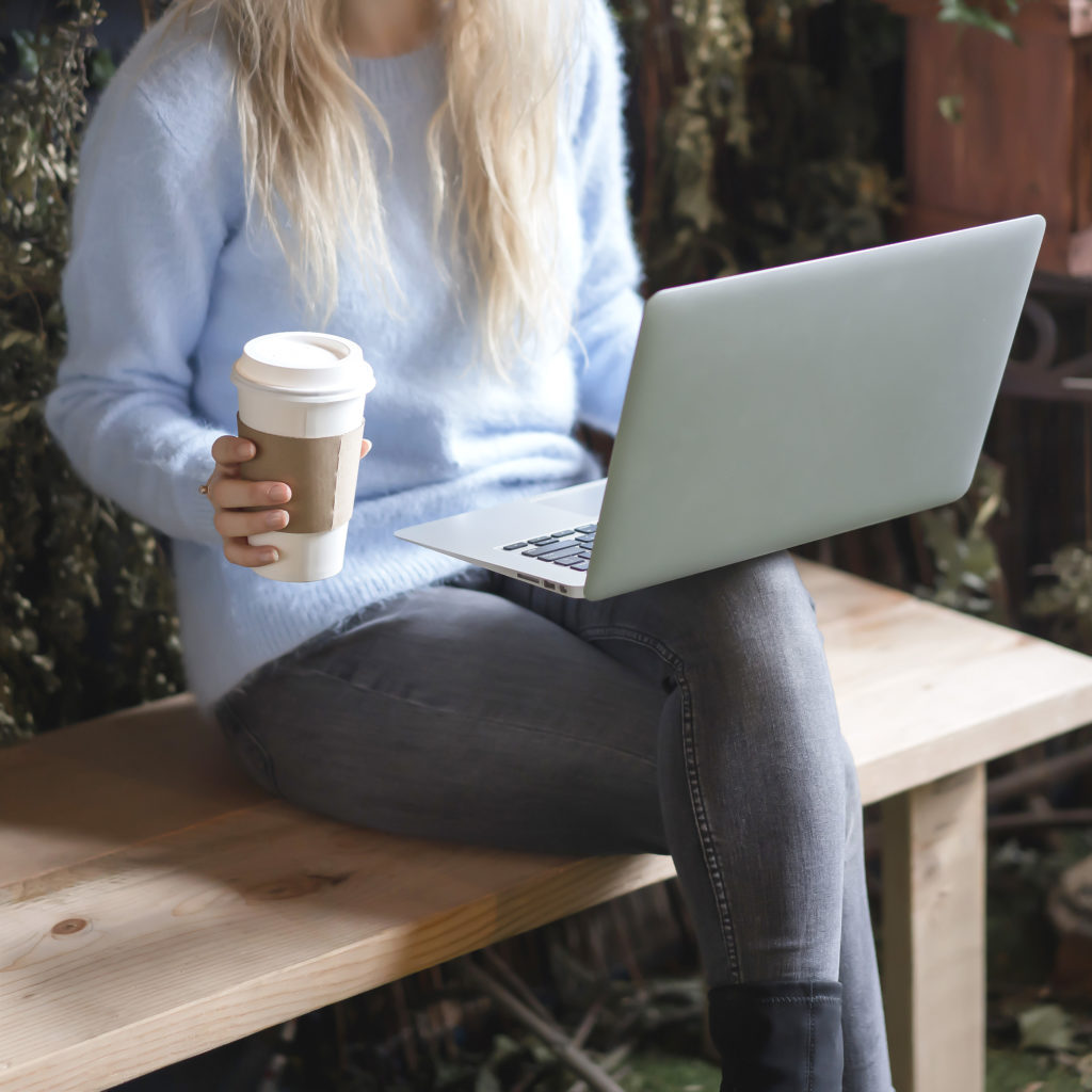 girl sitting with laptop and coffee